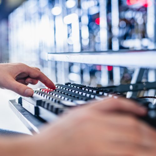 IT specialist working in bitcoin and crypto currency mining farm IT specialist working in bitcoin and crypto currency mining farm. Big data center. High tech server computers at work