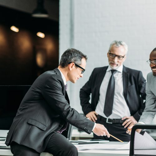 multiethnic businessmen discussing new business strategy on meeting in office multiethnic businessmen discussing new business strategy on meeting in office