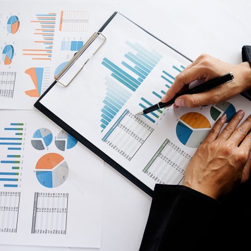 Business concept. Business people discussing the charts and graphs showing the results of their successful teamwork. Selective focus.Accounting