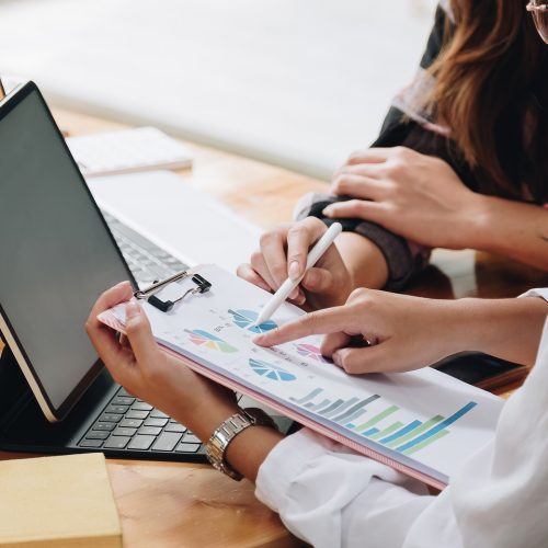 Two businesswomen discussing for financial chart report in office