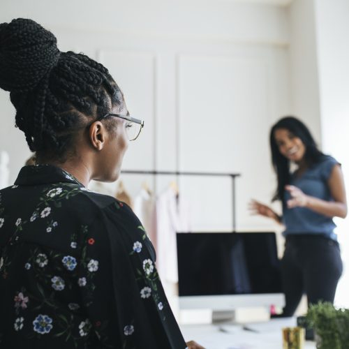 Fashion designers discussing their new clothing line Fashion designers discussing their new clothing line