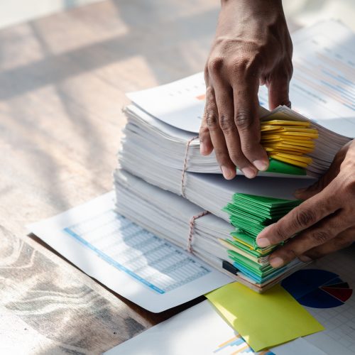 Businessman working, businessman looking at business documents a Businessman working, businessman looking at business documents and checking company finances, young startup company executive. Startup business management concept.