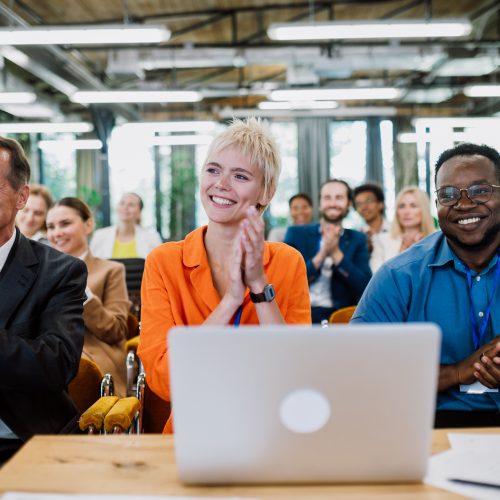 Cinematic image of a conference meeting. Business people sitting in a room listening to the motivator coach. Representation of a Self growth and improvement special event