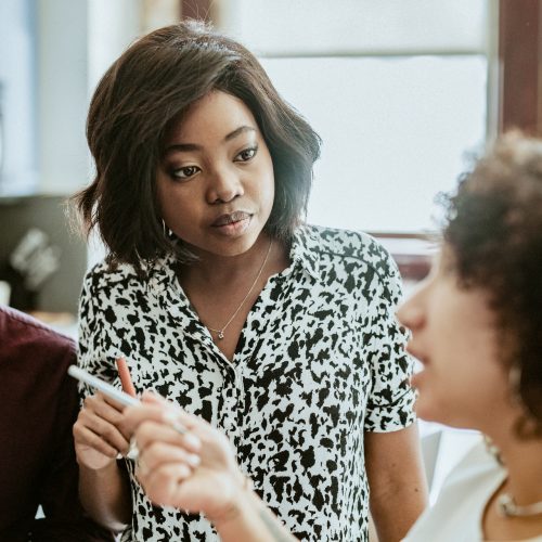 Diverse businesspeople in a startup company brainstorming in a meeting Diverse businesspeople in a startup company brainstorming in a meeting