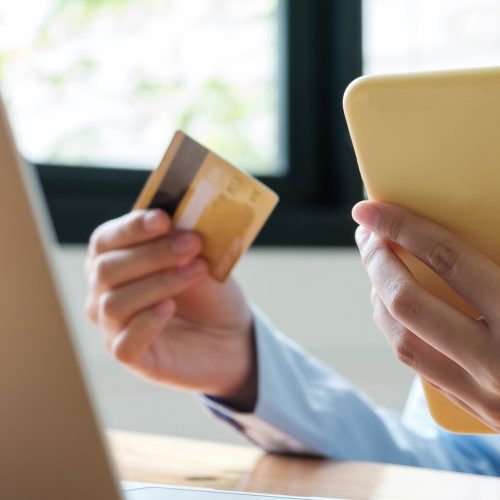 Online payment woman's hands holding smartphone and using credit card for online shopping. Cyber Monday Concept.