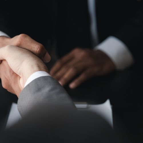 Business investor group holding hands, Two businessmen are agree Business investor group holding hands, Two businessmen are agreeing on business together and shaking hands after a successful negotiation. Handshaking is a Western greeting or congratulation.