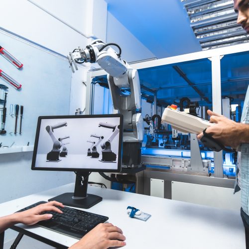 Meeting asian Engineers Maintenance Robot Arm at Lab. they are in a High Tech Research Laboratory with Modern Equipment. Technology and Innovation Concept.Professional Japanese Development Engineer is Testing an Artificial Intelligence.start up concept cyberspace with binary code.