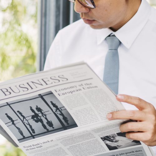 Businessman reading newspaper in the morning