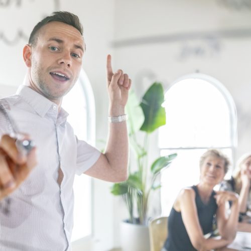 Businessman writing on a glass wall