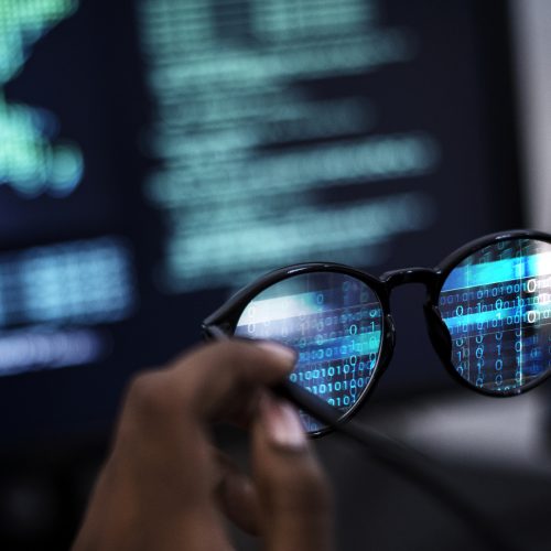 Closeup of a man holding a pair of glasses