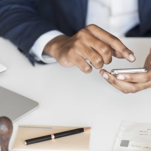 Closeup of businessman using mobile phone